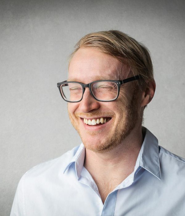 Person smiling and looking energetic after a workout session, with warm light.
